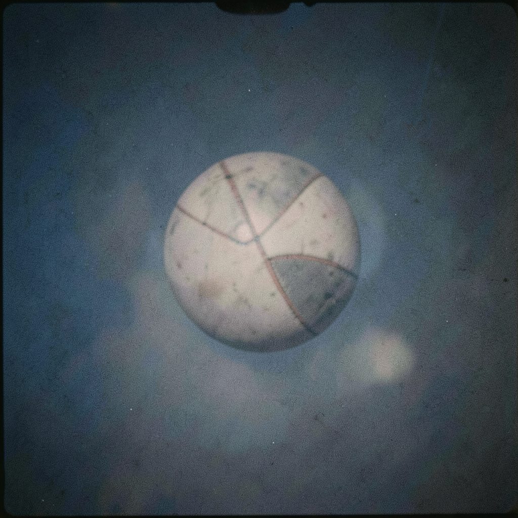 Analog photograph of album artwork mood: rich indigo and gold abstract shapes suggesting a gospel record sleeve, grainy and warm